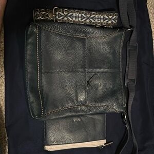 The Sak messenger purse with wallet and extra strap navy blue in color.